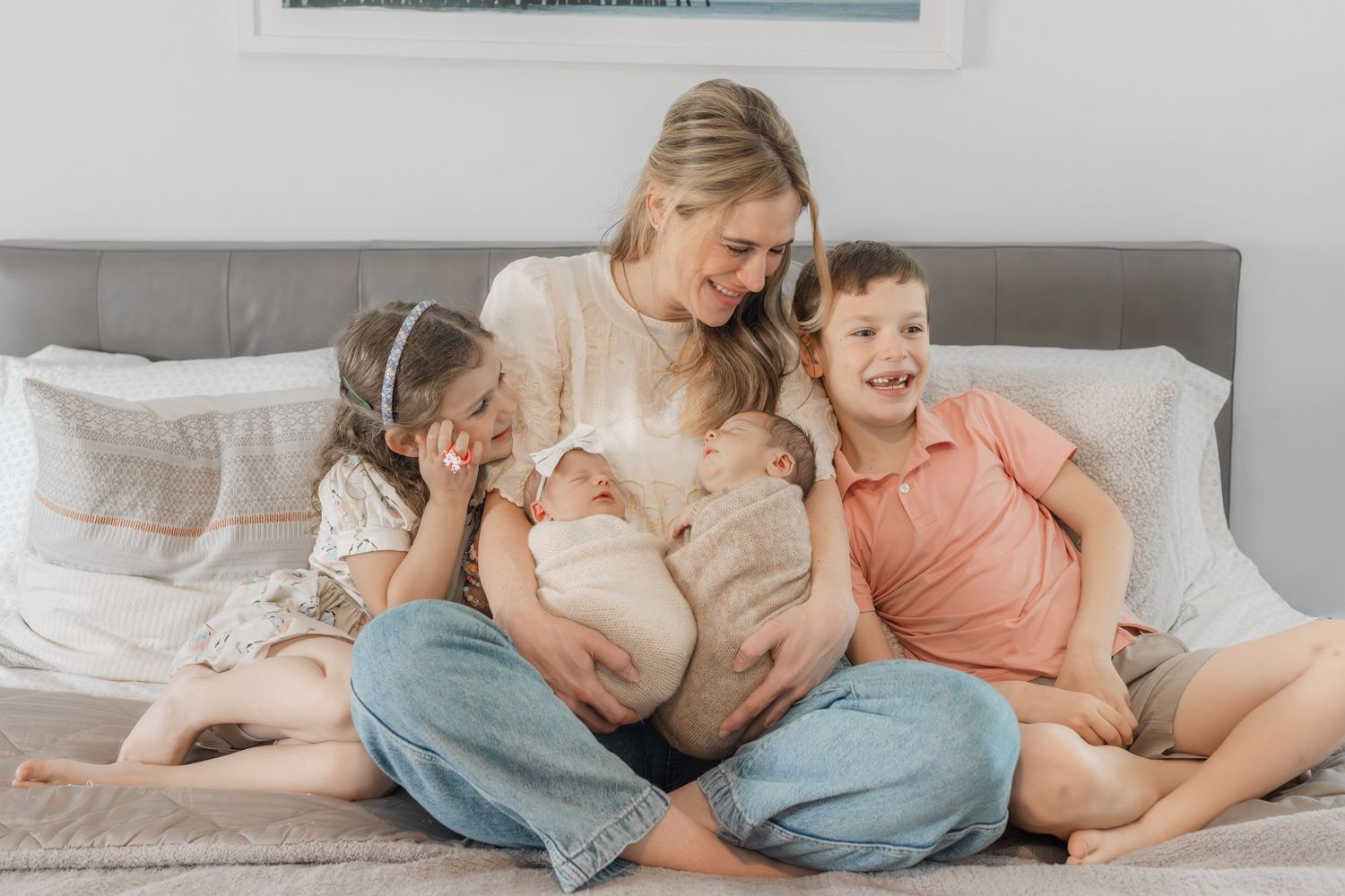 A series of tender family moments captured in soft, muted tones as they relax together at home on a bed.