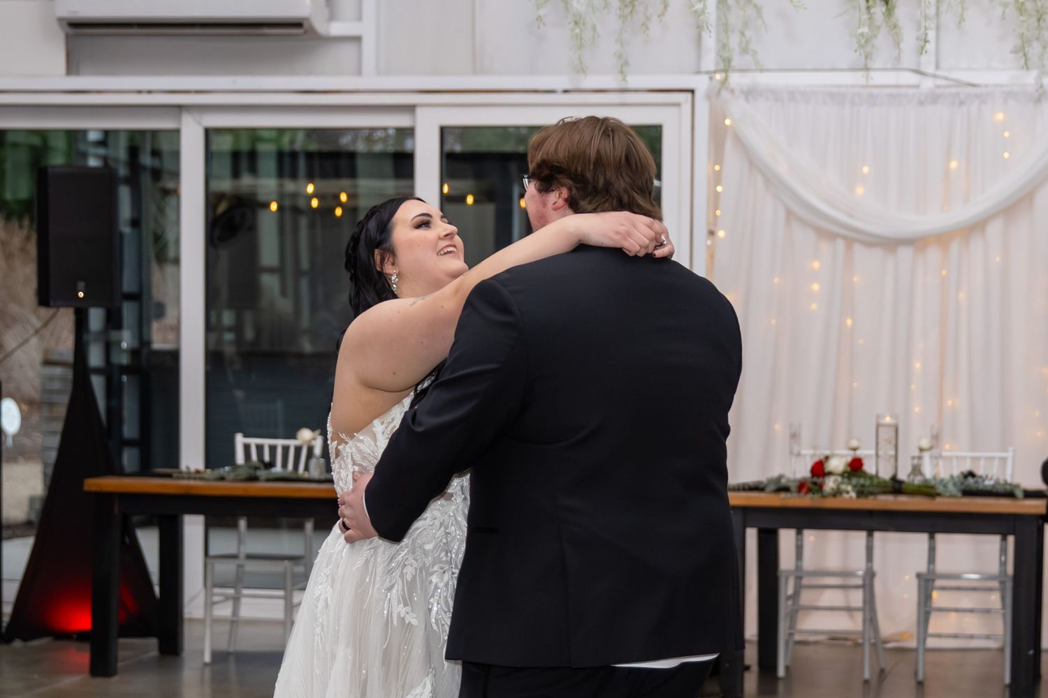 Bride and groom sharing their first dance at a romantic wedding reception venue.