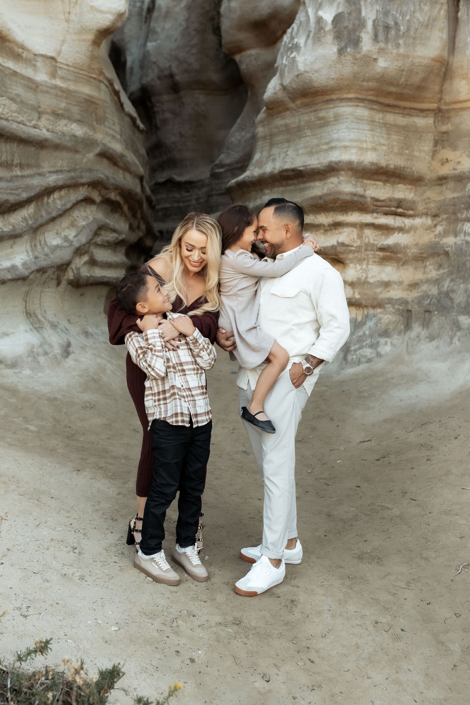 A family snuggling during a photo session in San Clemente, CA