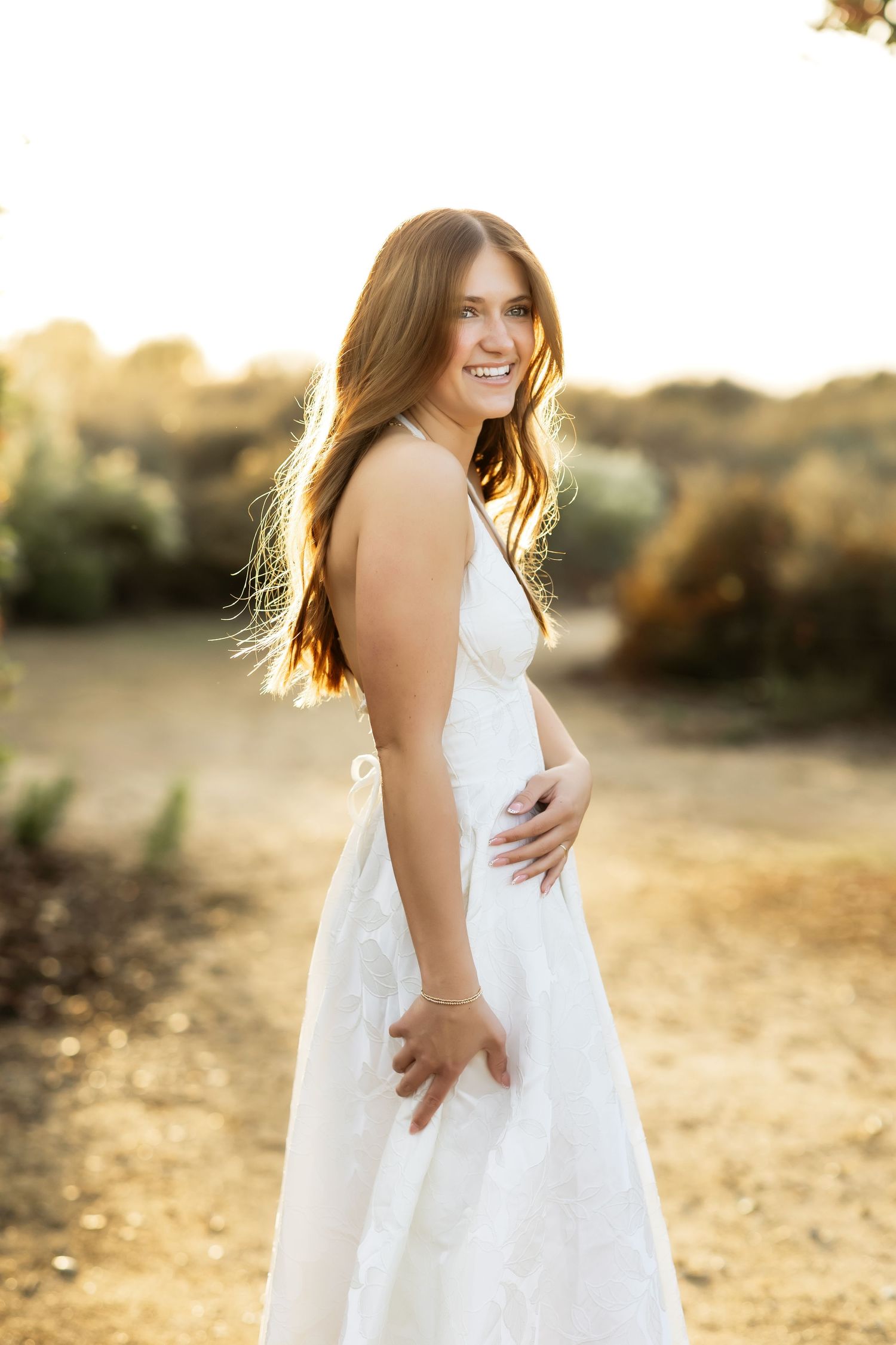 Senior portrait of girl on a trail during golden hour in Fullerton, CA
