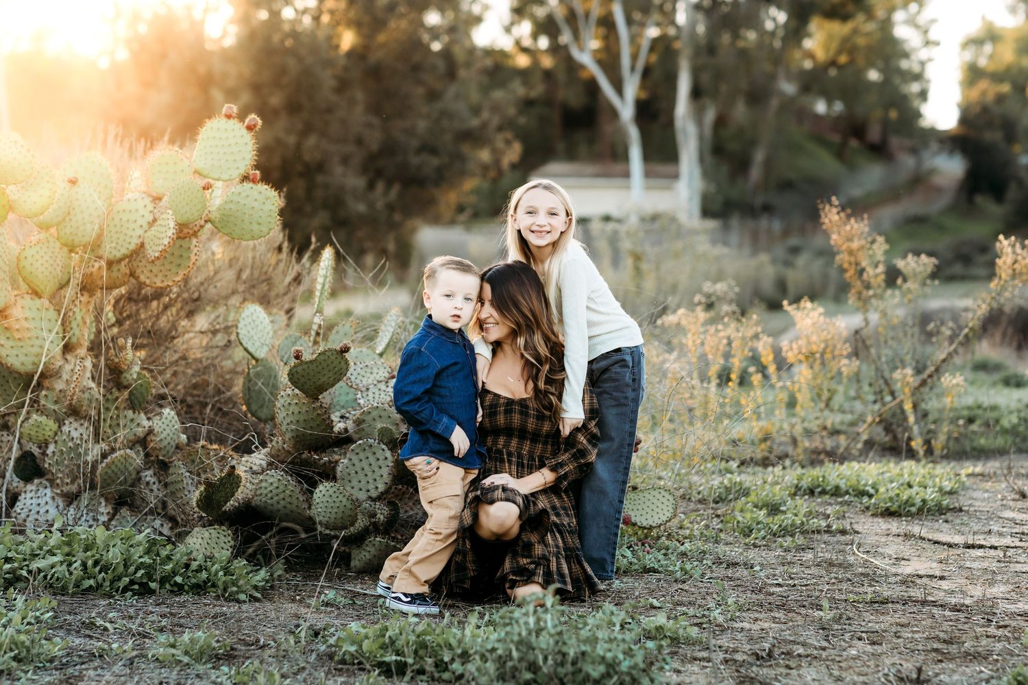 Sunset photo of mom and her little kids during a family session in Fullerton, CA