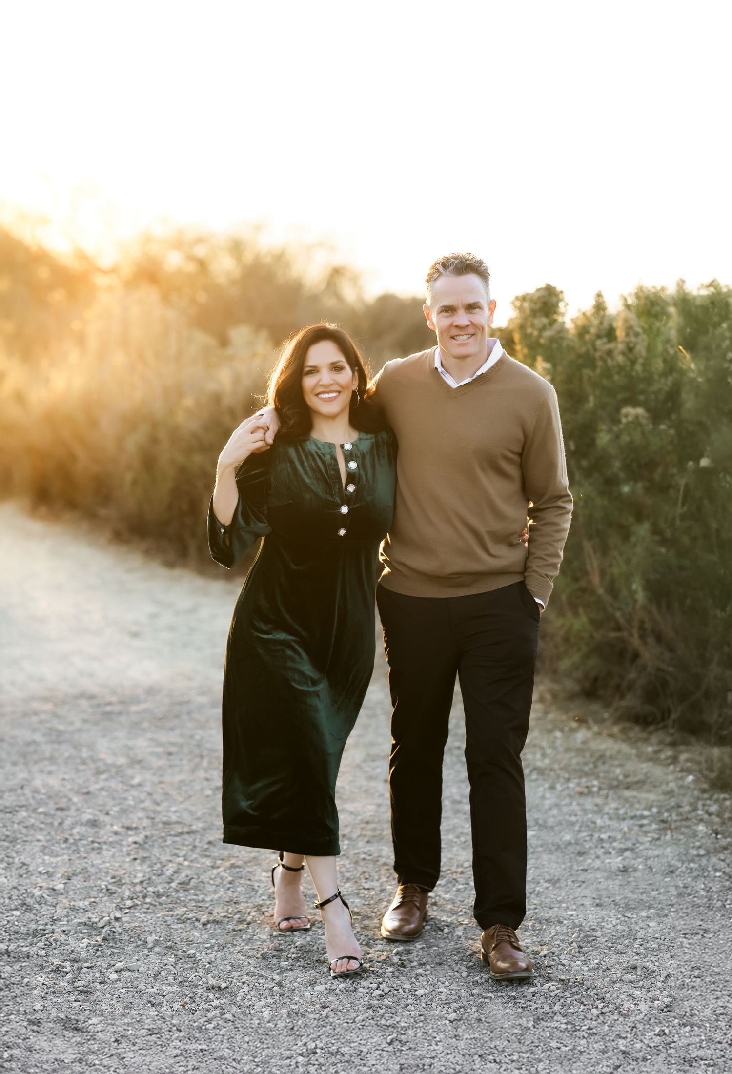 A couple walking along a trail during sunset at a family photo session in Orange County