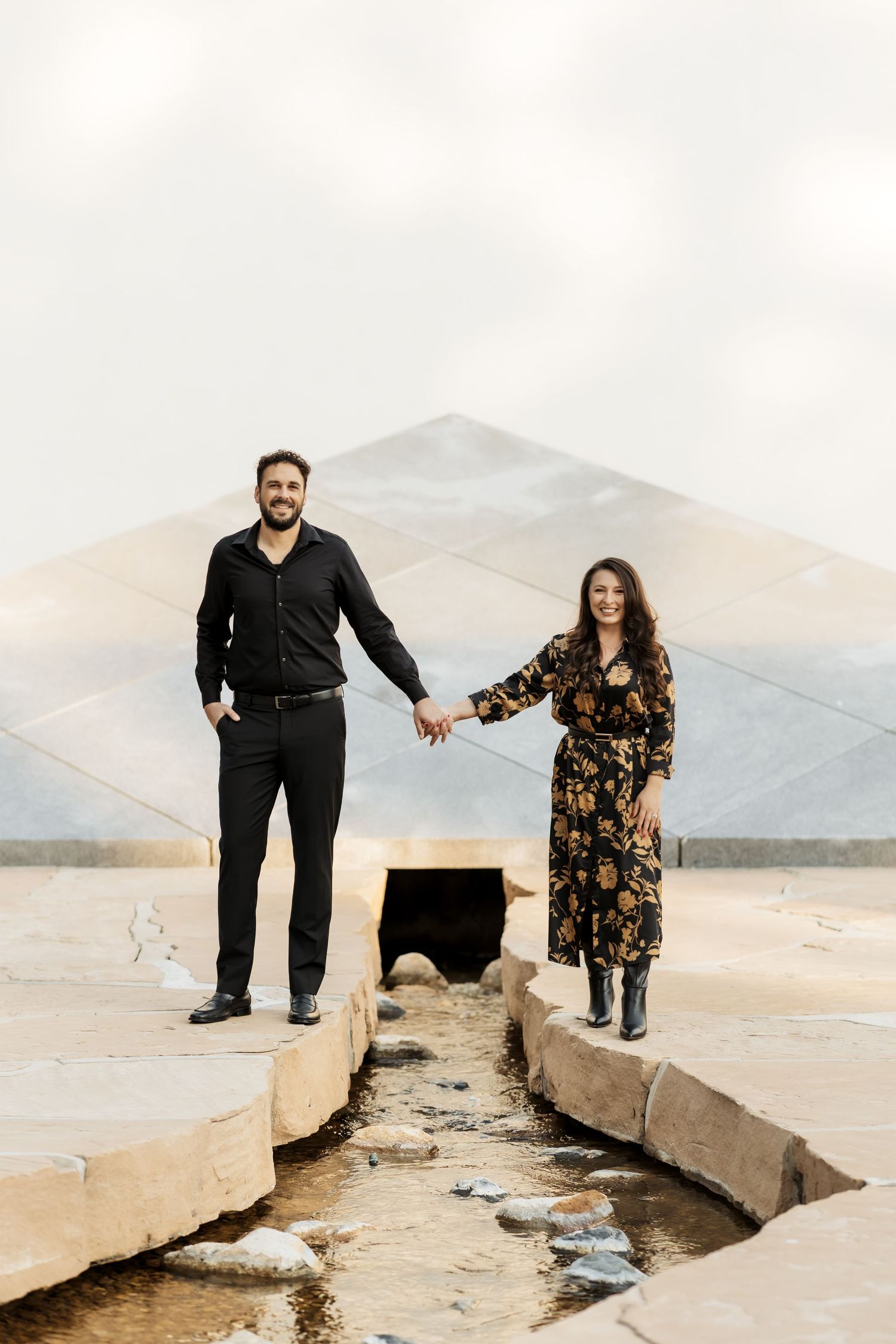A couple holding hands during an outdoor photo session in Orange County