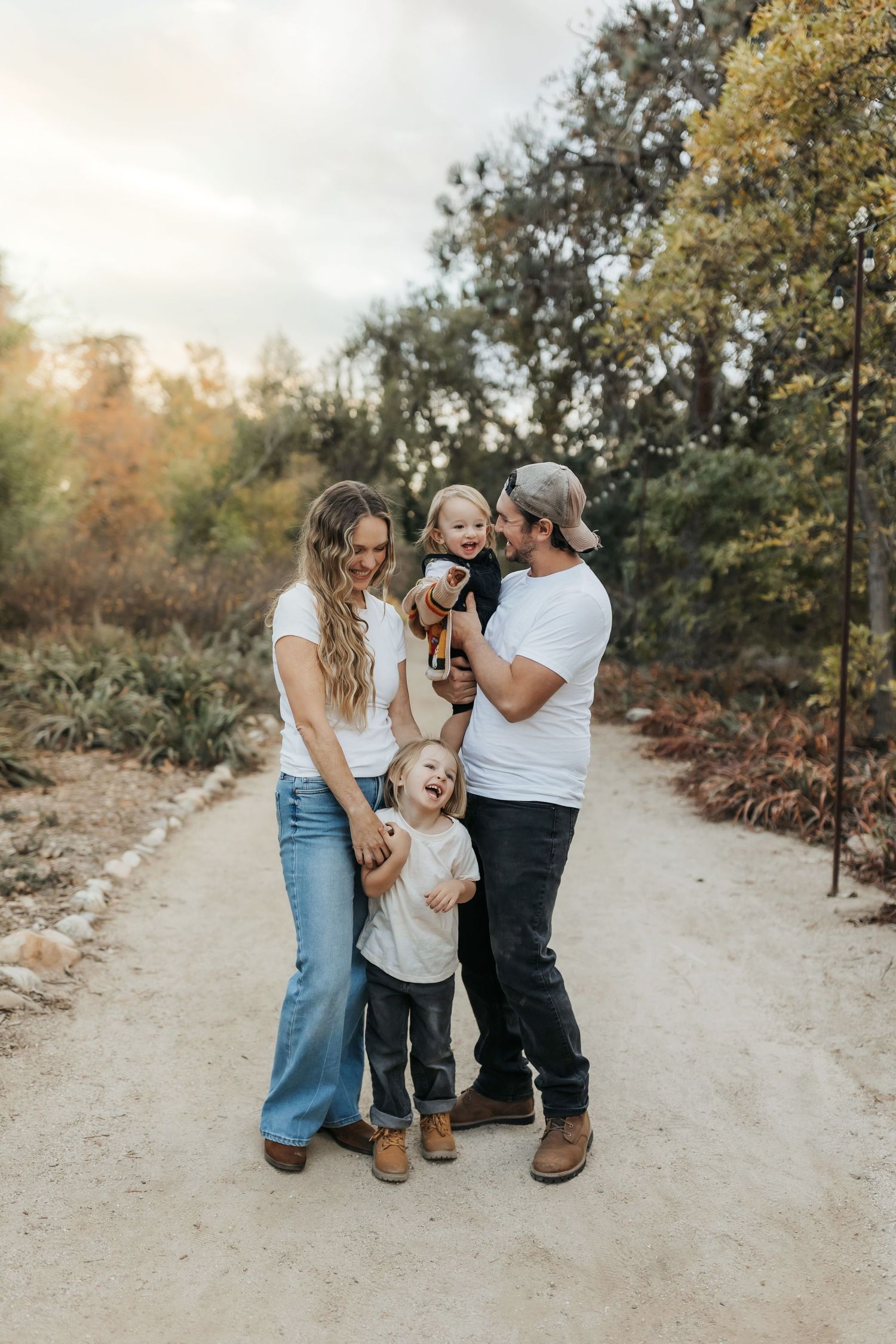 Parents hugging and tickling their children during a family photo session in Orange County