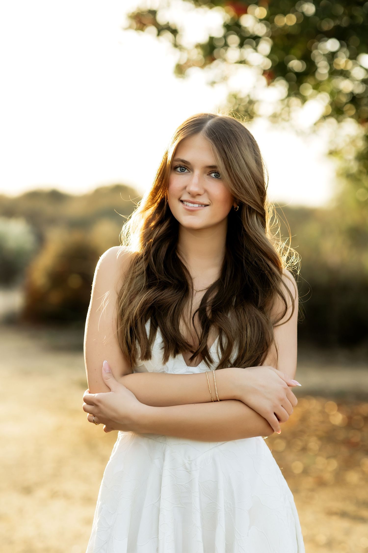 High School senior smiling during graduation portrait session in Fullerton, CA.