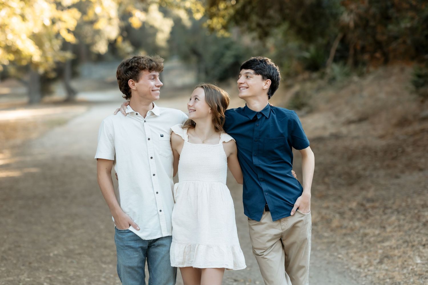 Siblings looking at each other laughing during a family photo session in Orange County