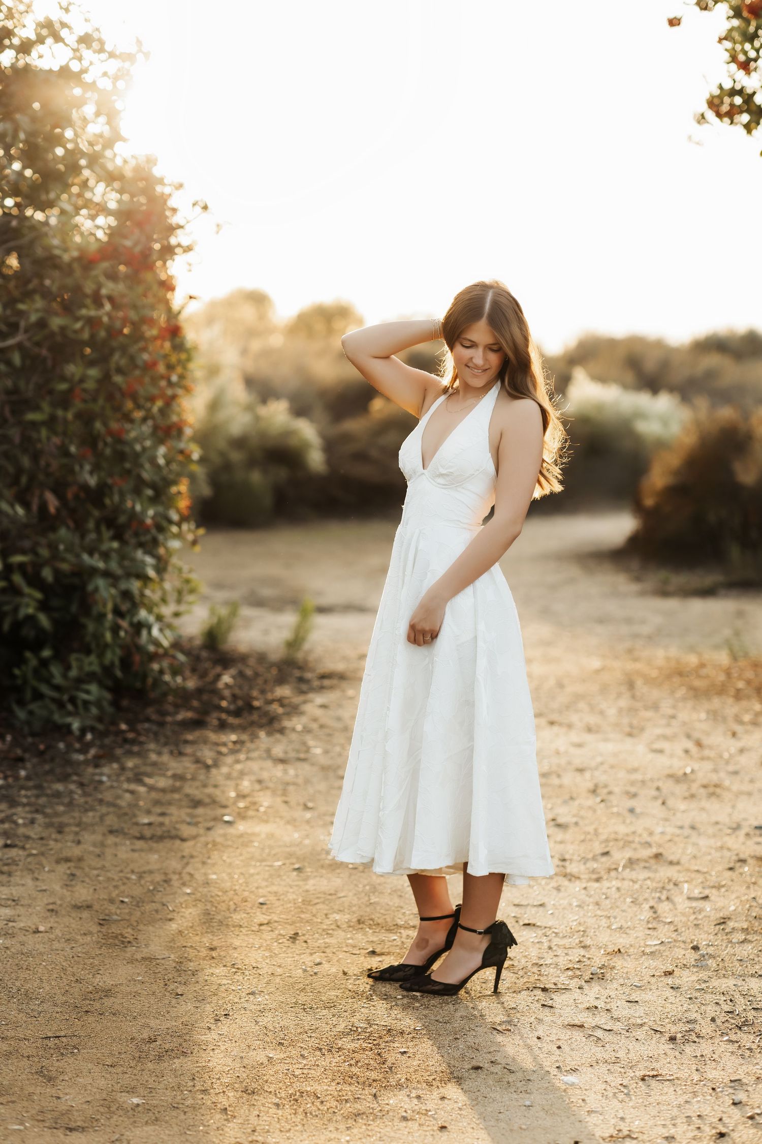 Senior portrait of girl on a trail during golden hour in Fullerton, CA