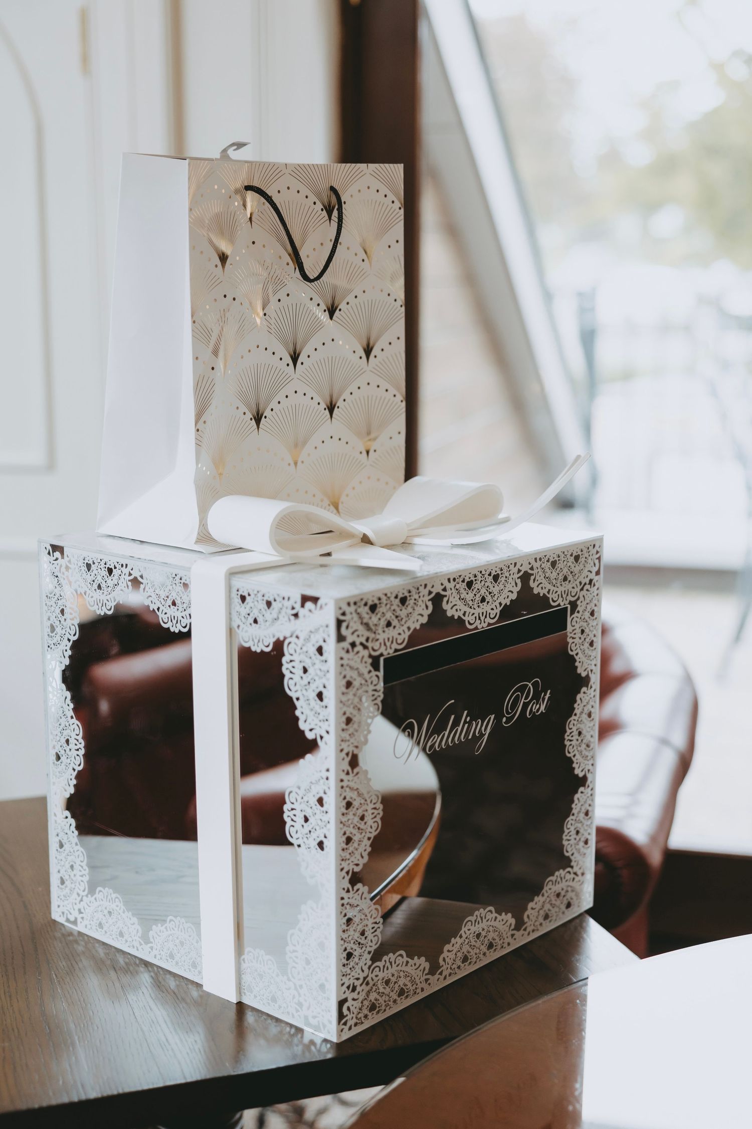 Elegant white lace-detailed wedding gift boxes arranged on a table.
