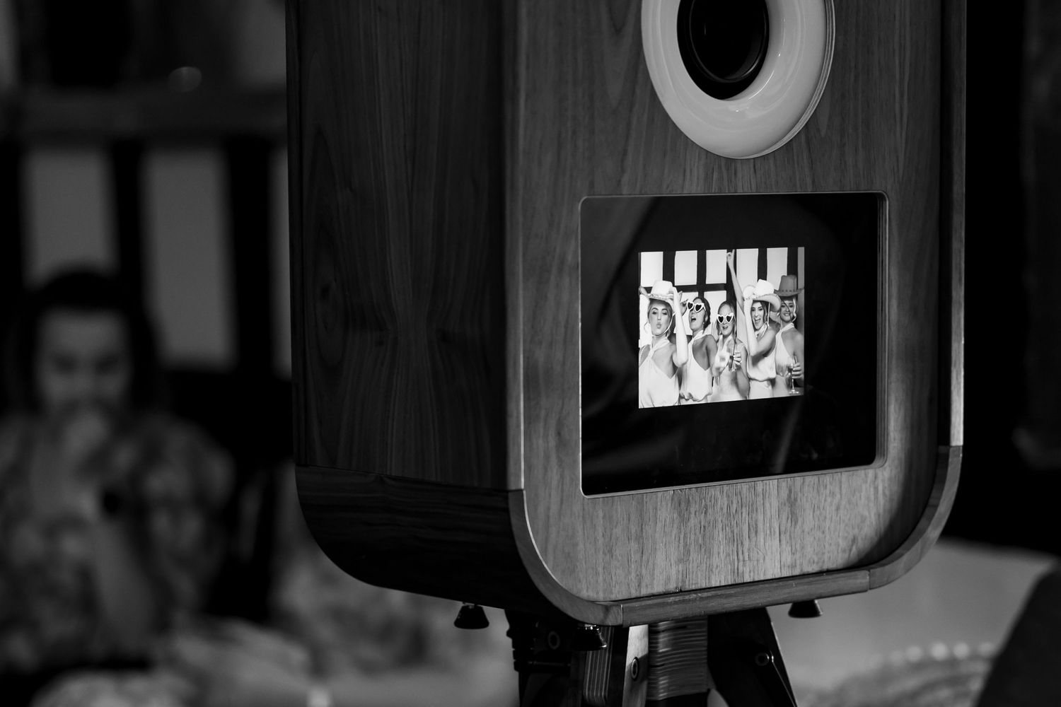Rustic wooden photo display boxes mounted on dark wall with circular frame details.