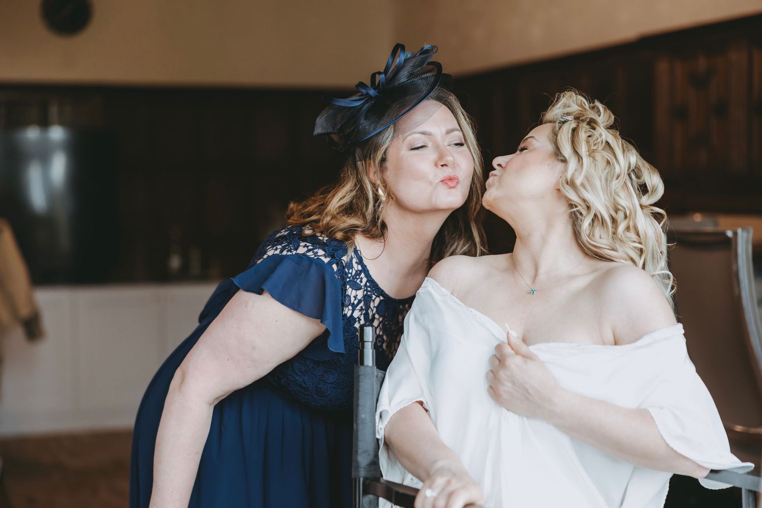A celebratory moment captured between people in formal attire at an elegant indoor event.