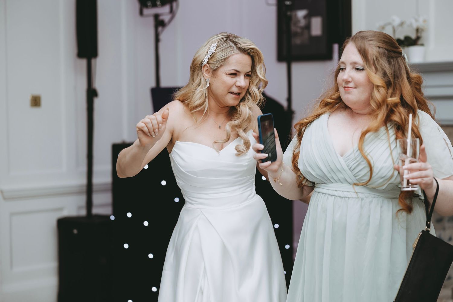 Candid moments of wedding party members laughing together in formal attire against white walls.