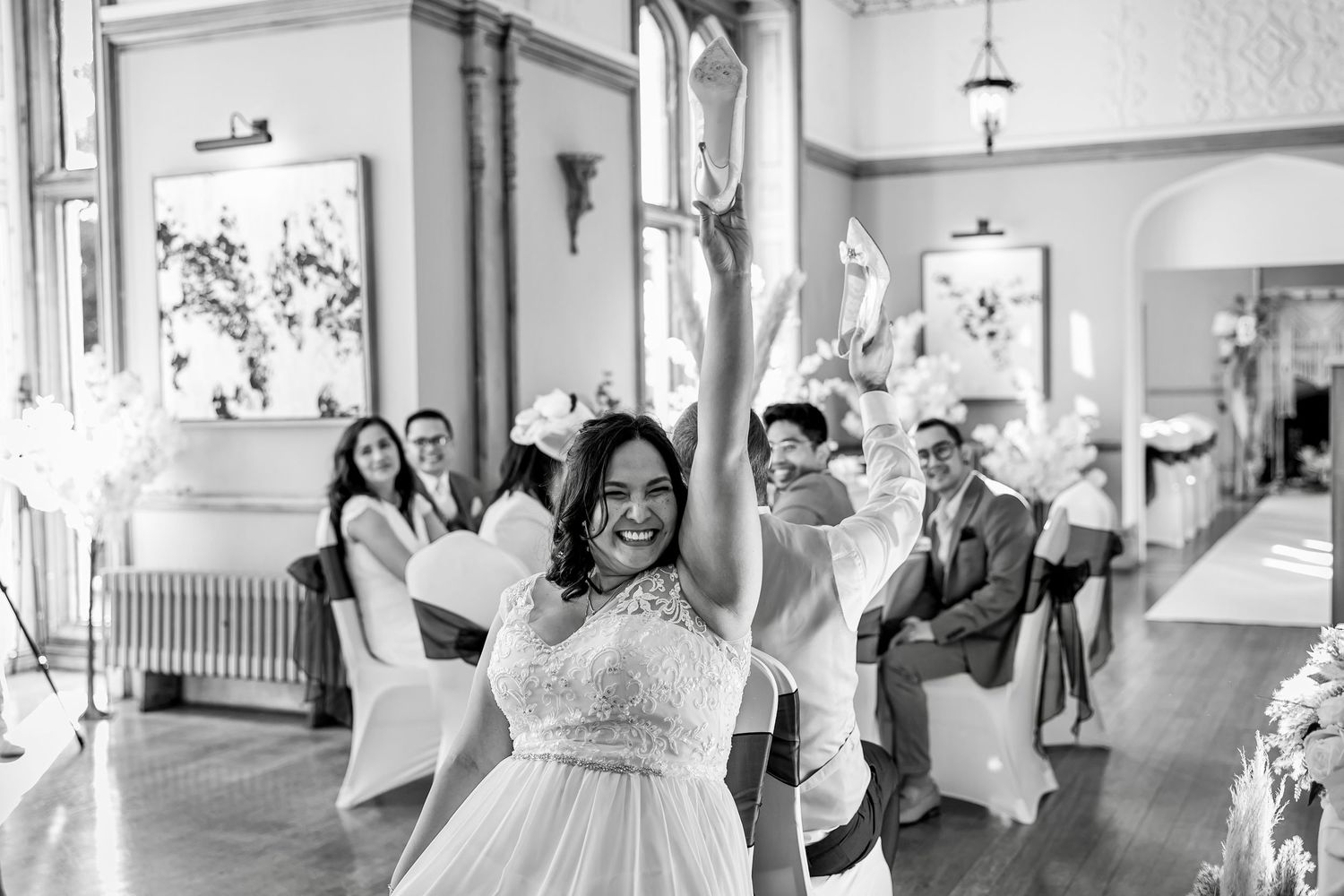 Wedding celebration in an elegant venue with bright windows and natural light.