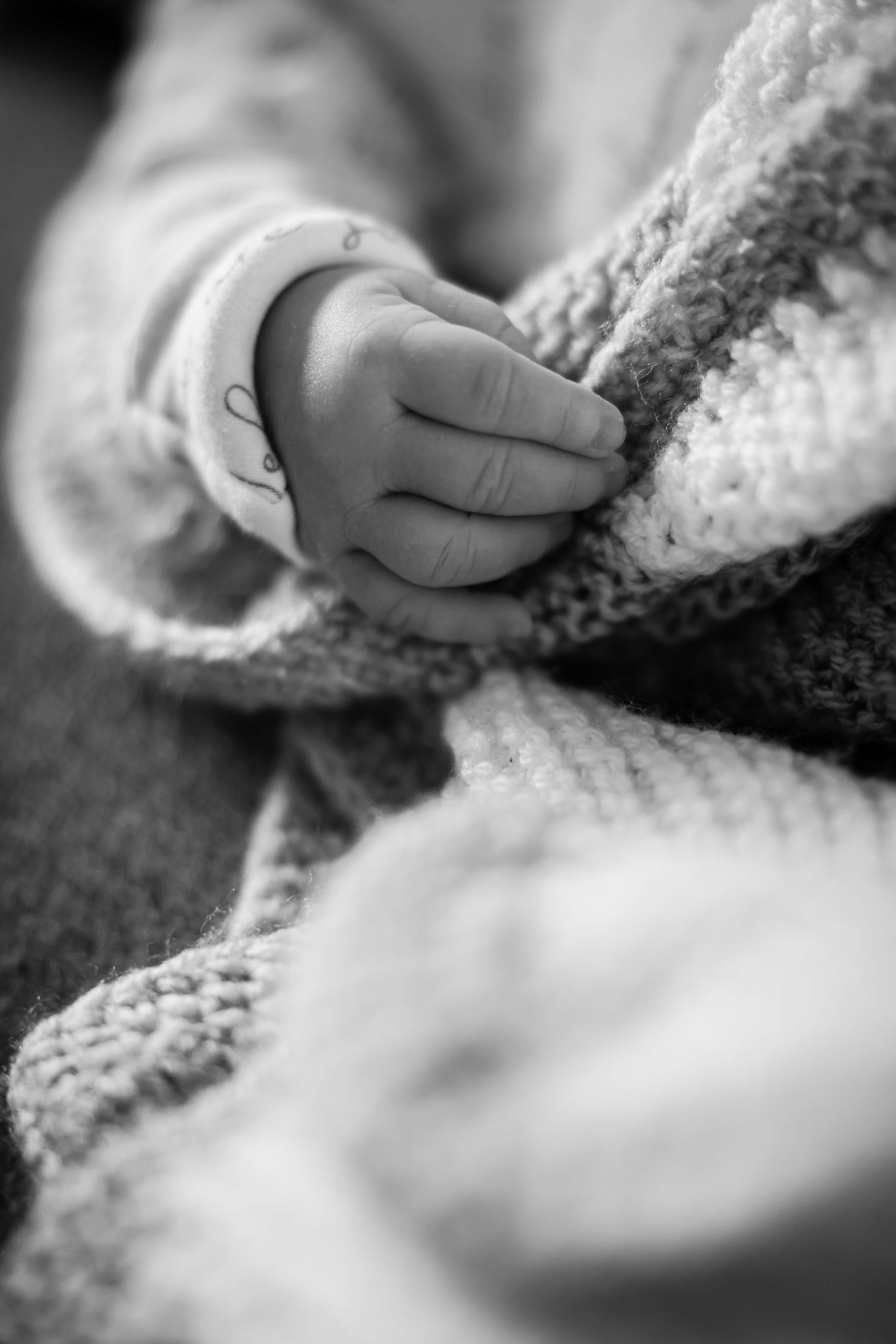 A close-up sequence of small hands touching and exploring soft white snow on the ground.