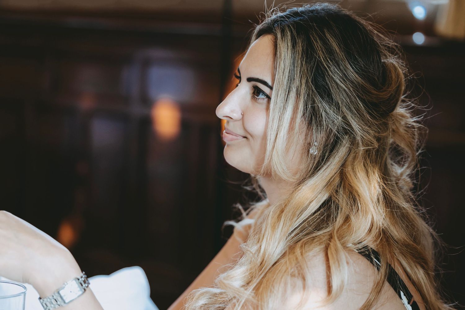 Natural light illuminates guests at a formal indoor gathering.
