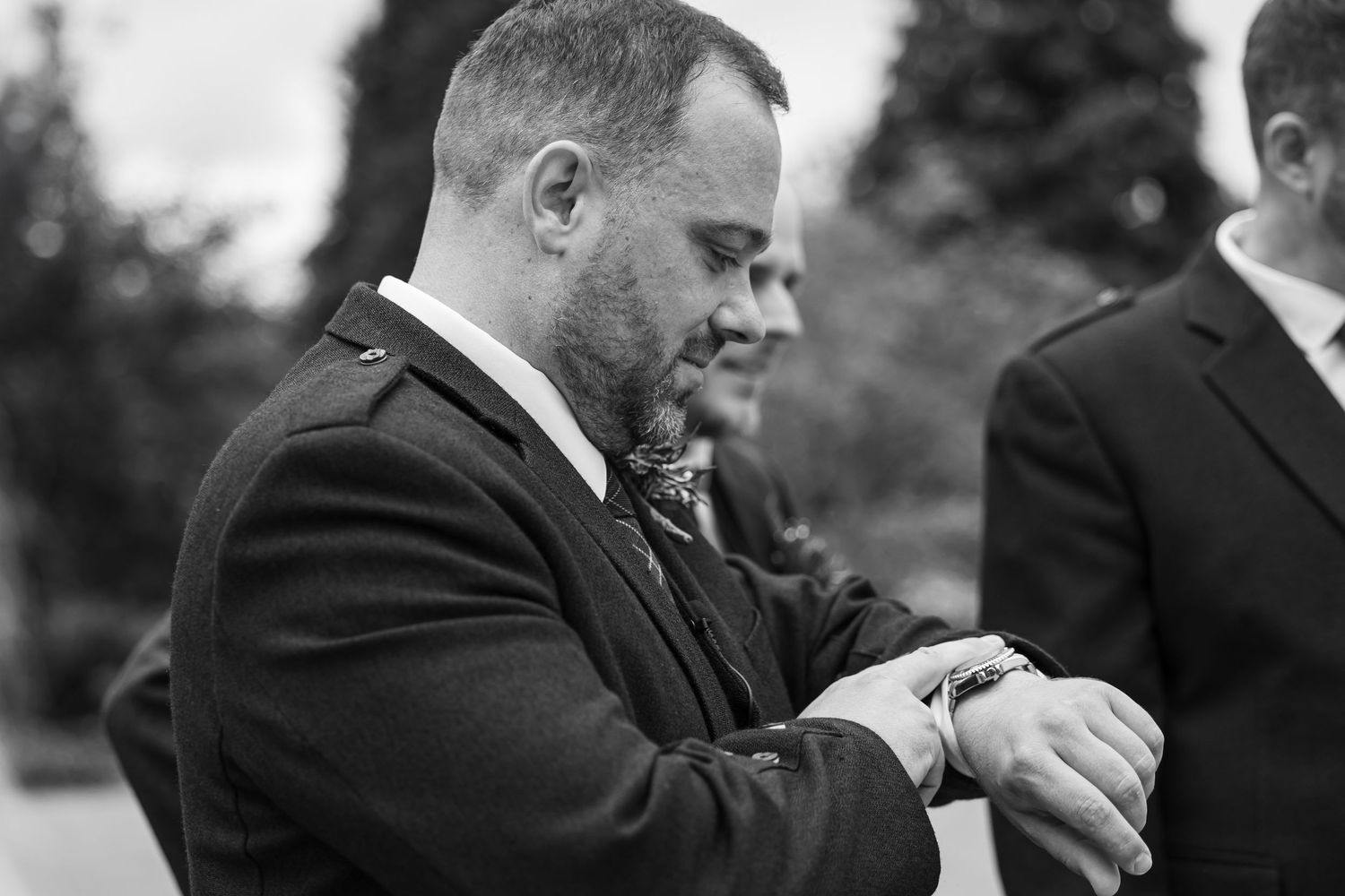 Black and white photo of guests at formal outdoor event.