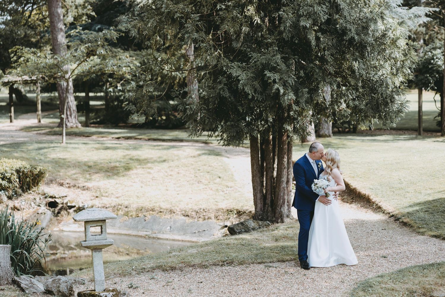 Romantic wedding photography session featuring a red garden bridge backdrop.