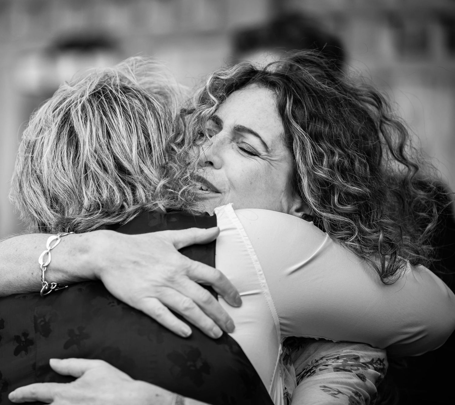 An emotional black and white photograph capturing a warm embrace.
