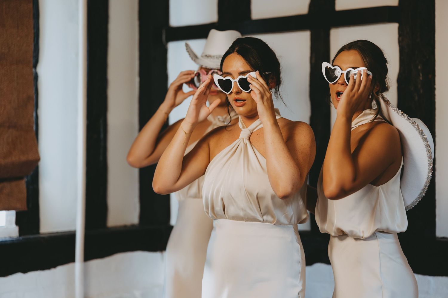 Creative wedding photo series showing playful poses against a black and white geometric background.