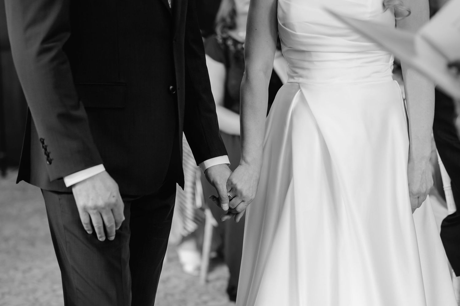 Wedding party members in formal attire standing together during celebration.