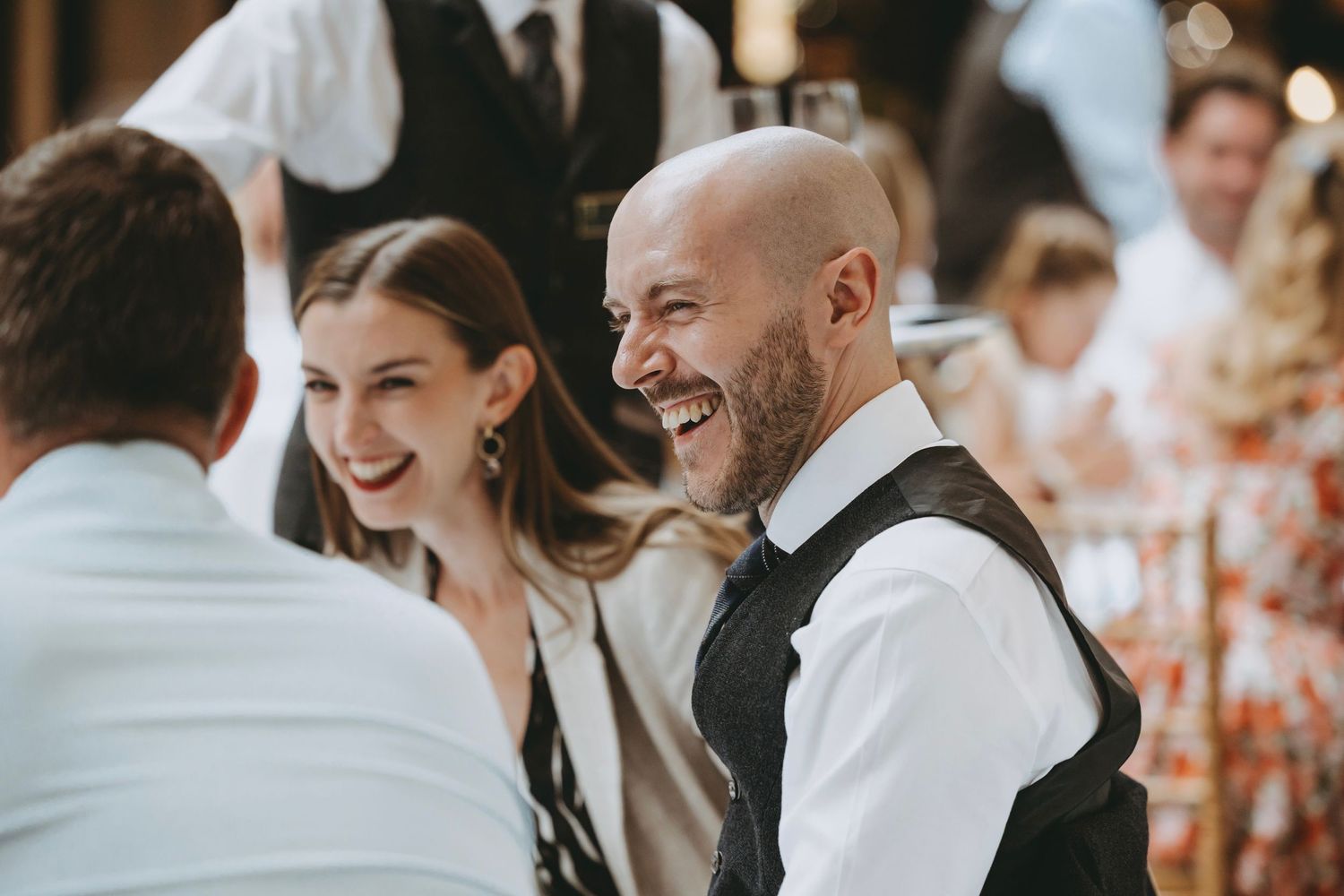 Wedding guests share a joyful moment during the reception celebration.