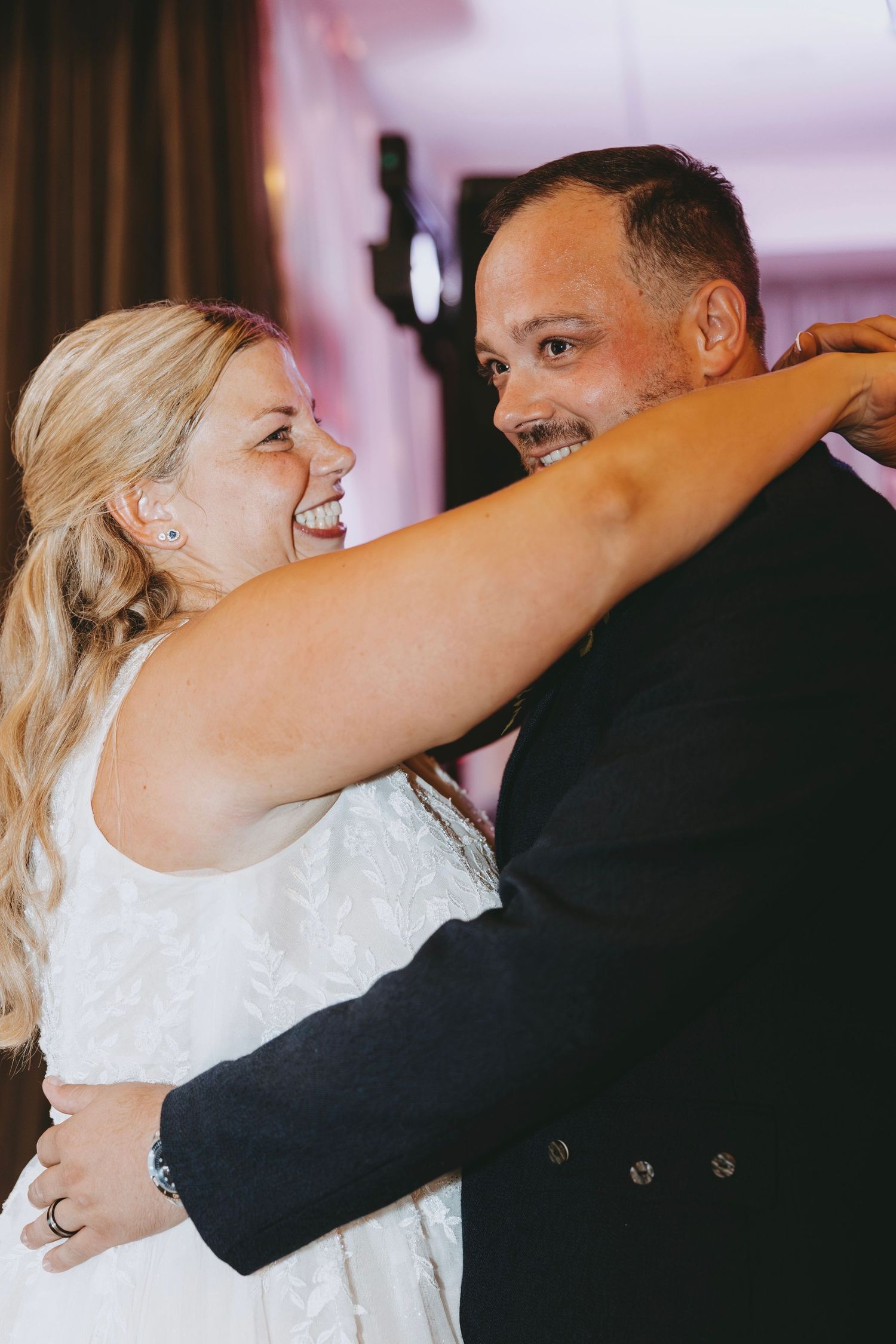 Couple sharing an intimate dance moment in formal wedding attire.