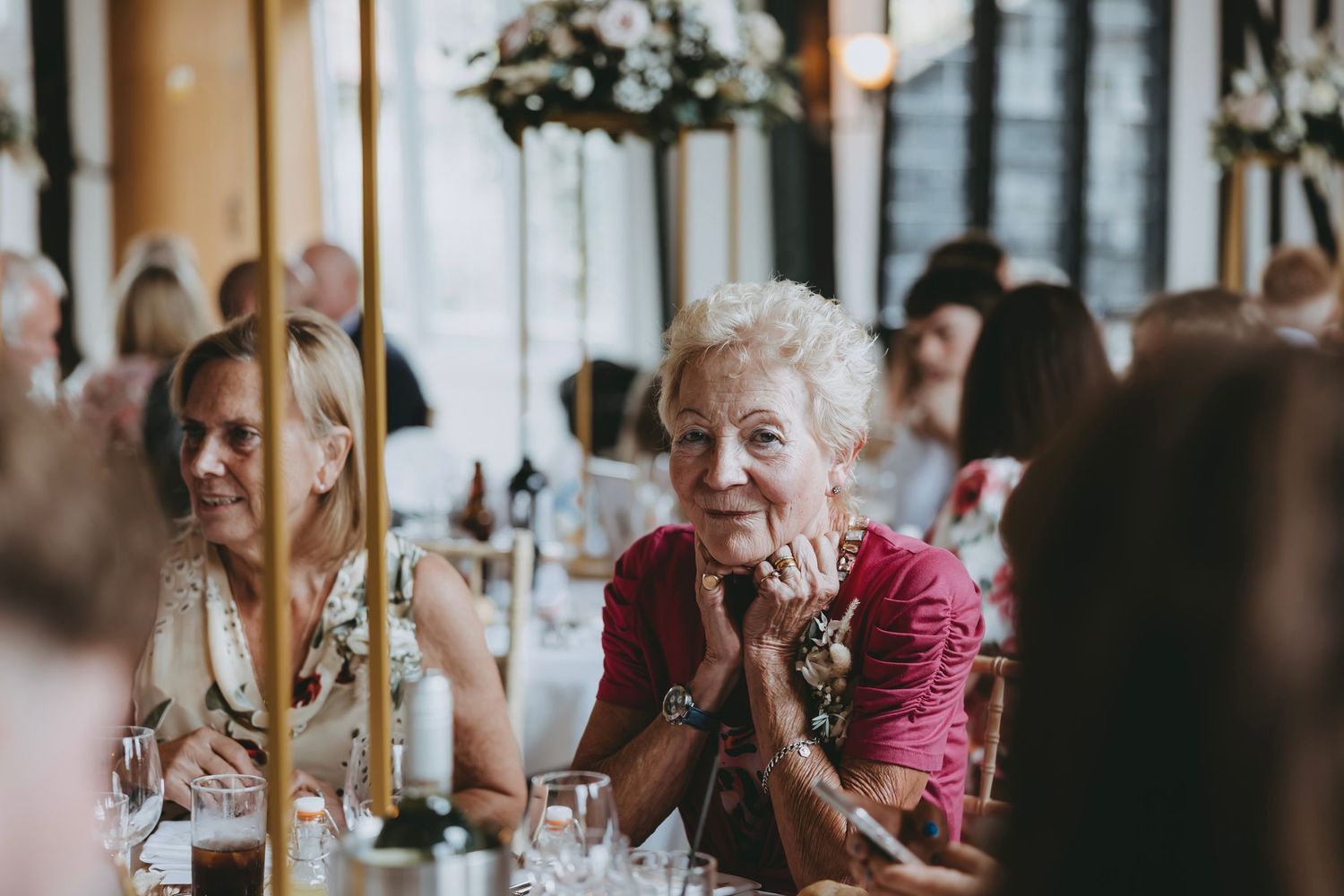 Wedding guests reacting emotionally during a reception celebration.