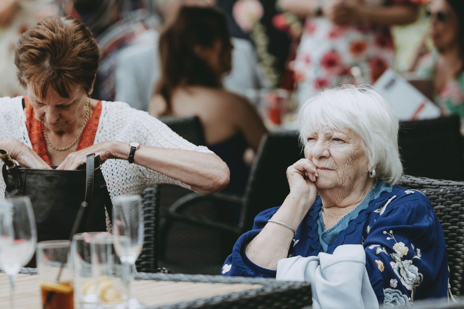 Wedding guests enjoying a reception meal at decorated tables.