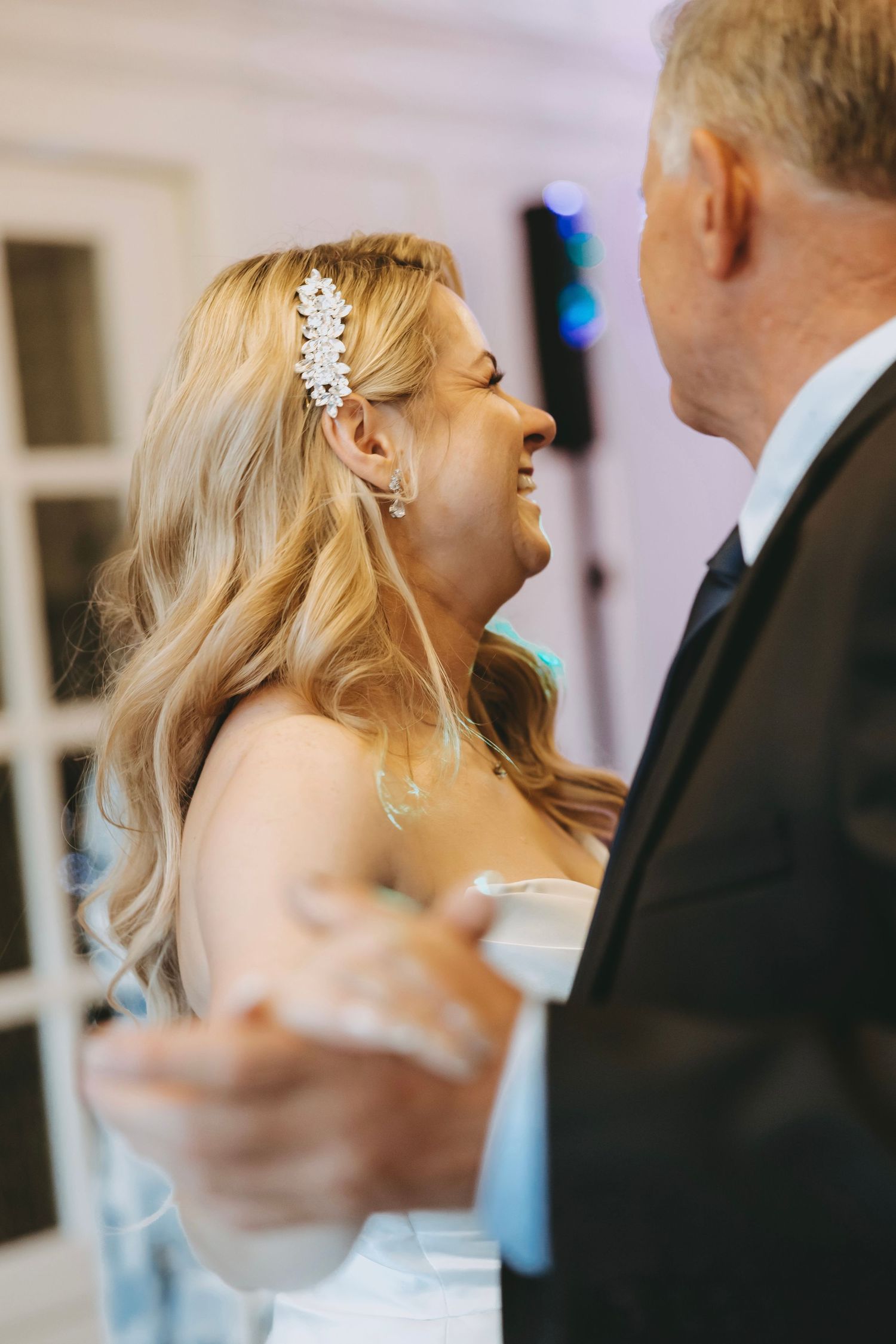 Close up of couple dancing together at formal event.