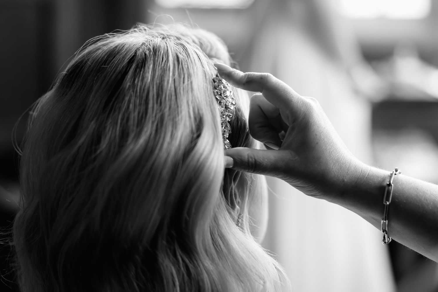 Close-up shot of wedding day hair and makeup preparations in natural light.