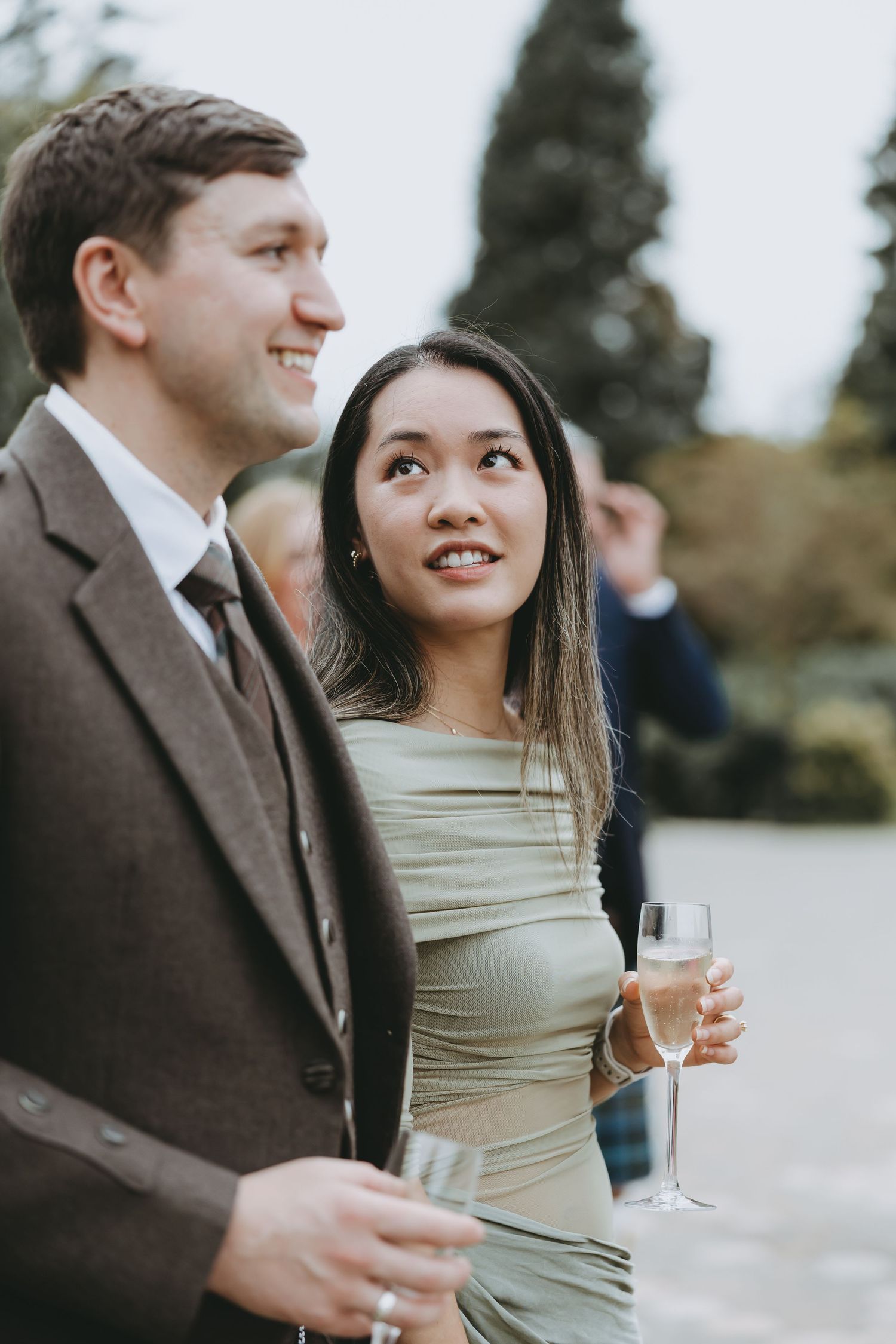 Guests enjoying champagne at an elegant outdoor event.