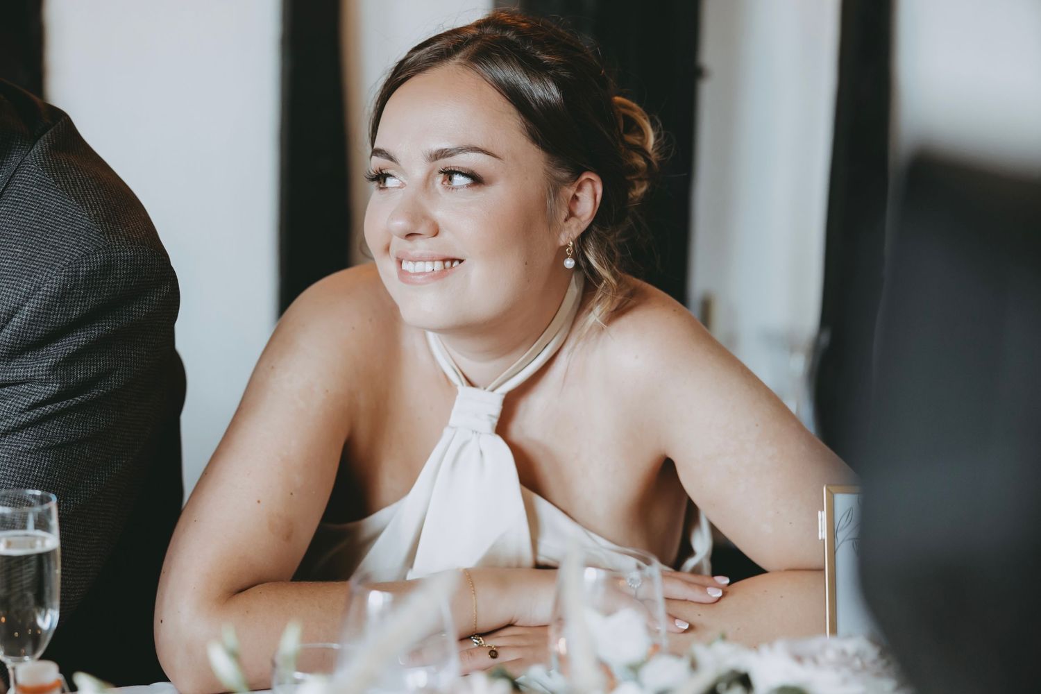 Wedding guests smiling and enjoying reception festivities.