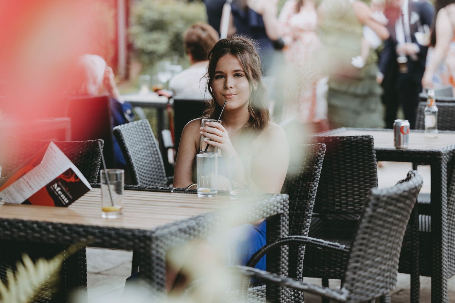 Guests seated at outdoor patio furniture during an event.