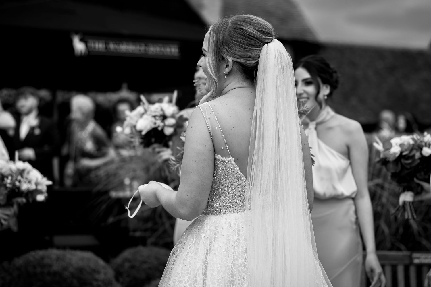 Candid moments from an outdoor wedding with bridal party in white dresses.
