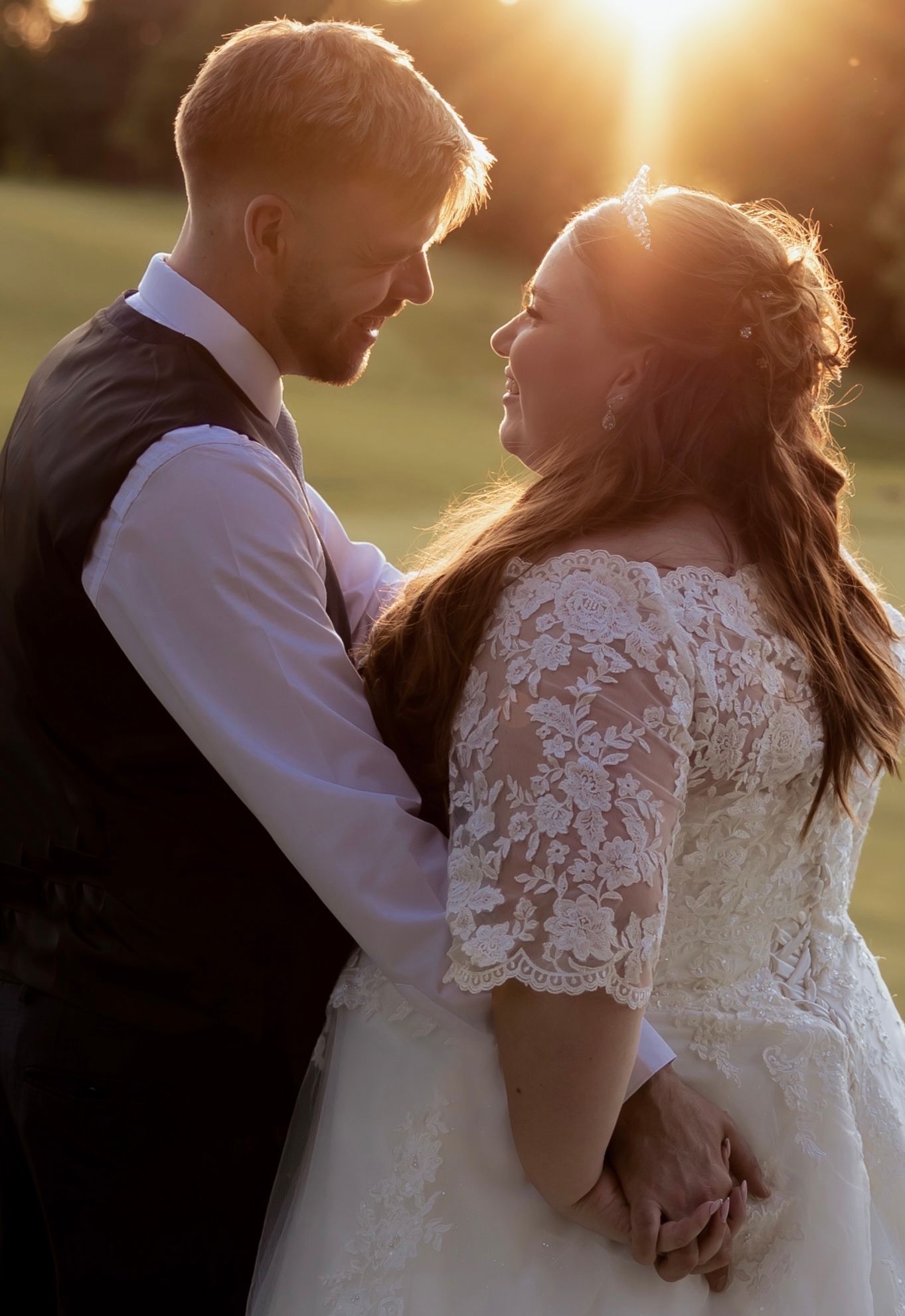 A romantic sunset portrait of newlyweds sharing an intimate moment.