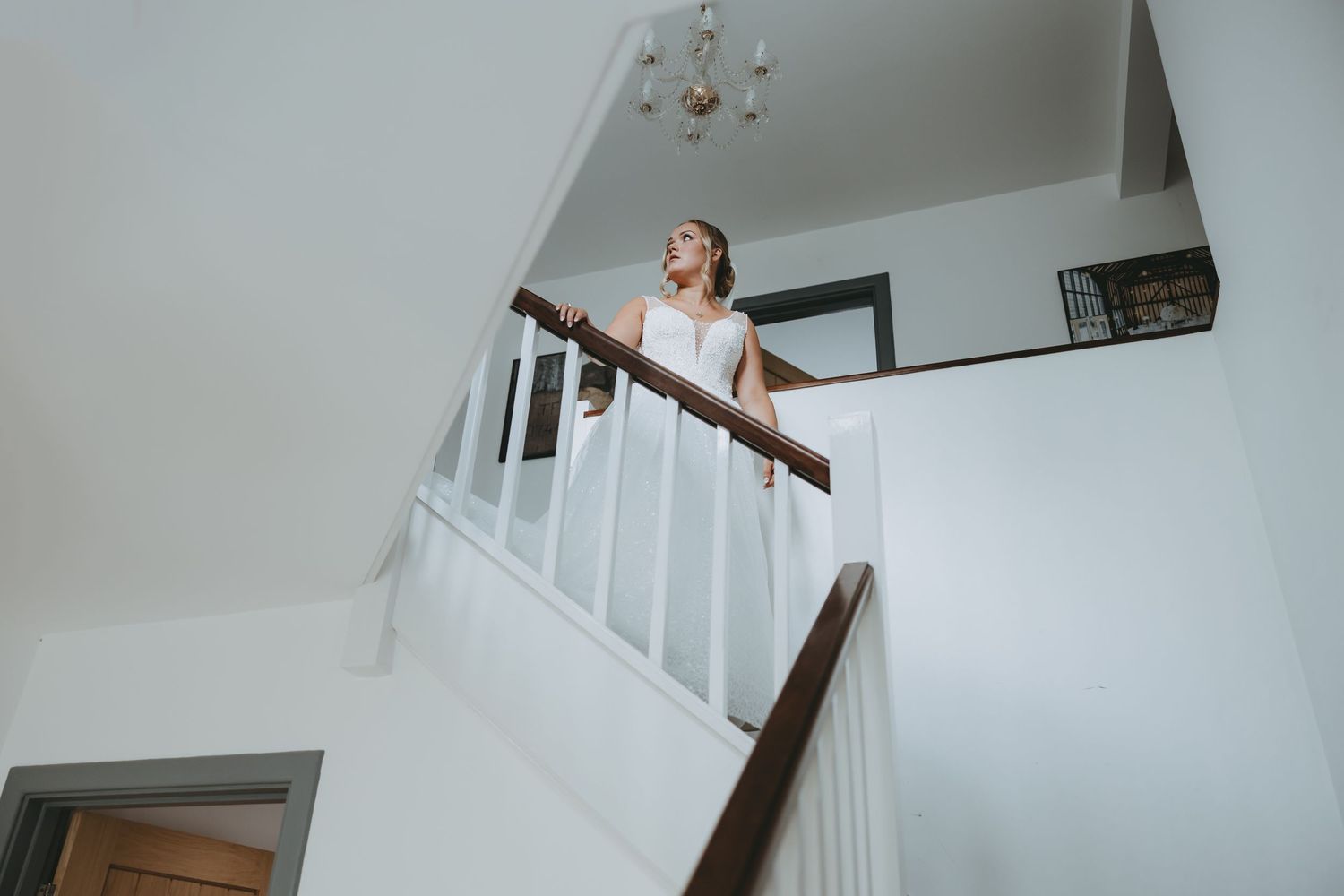 Elegant staircase reveal moment during a wedding celebration.