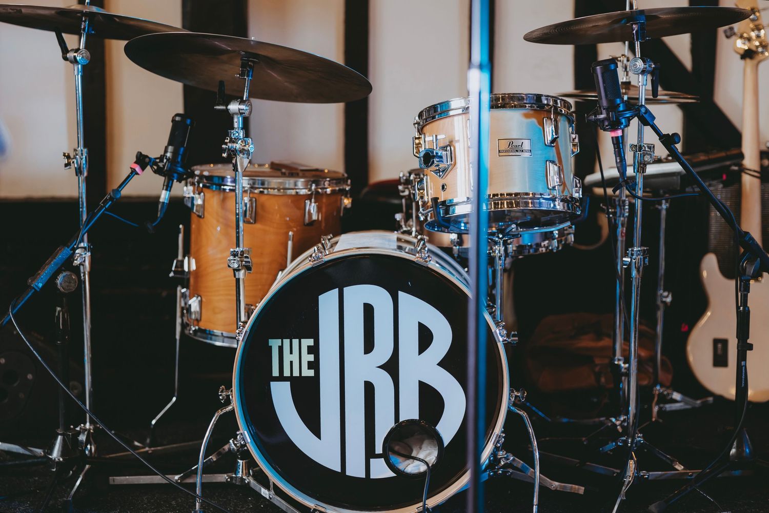 Professional drum kit setup with JRB logo on stage at wedding reception venue.