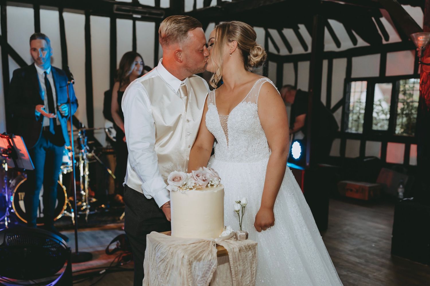 Romantic moment between newlyweds sharing wedding cake at their reception.
