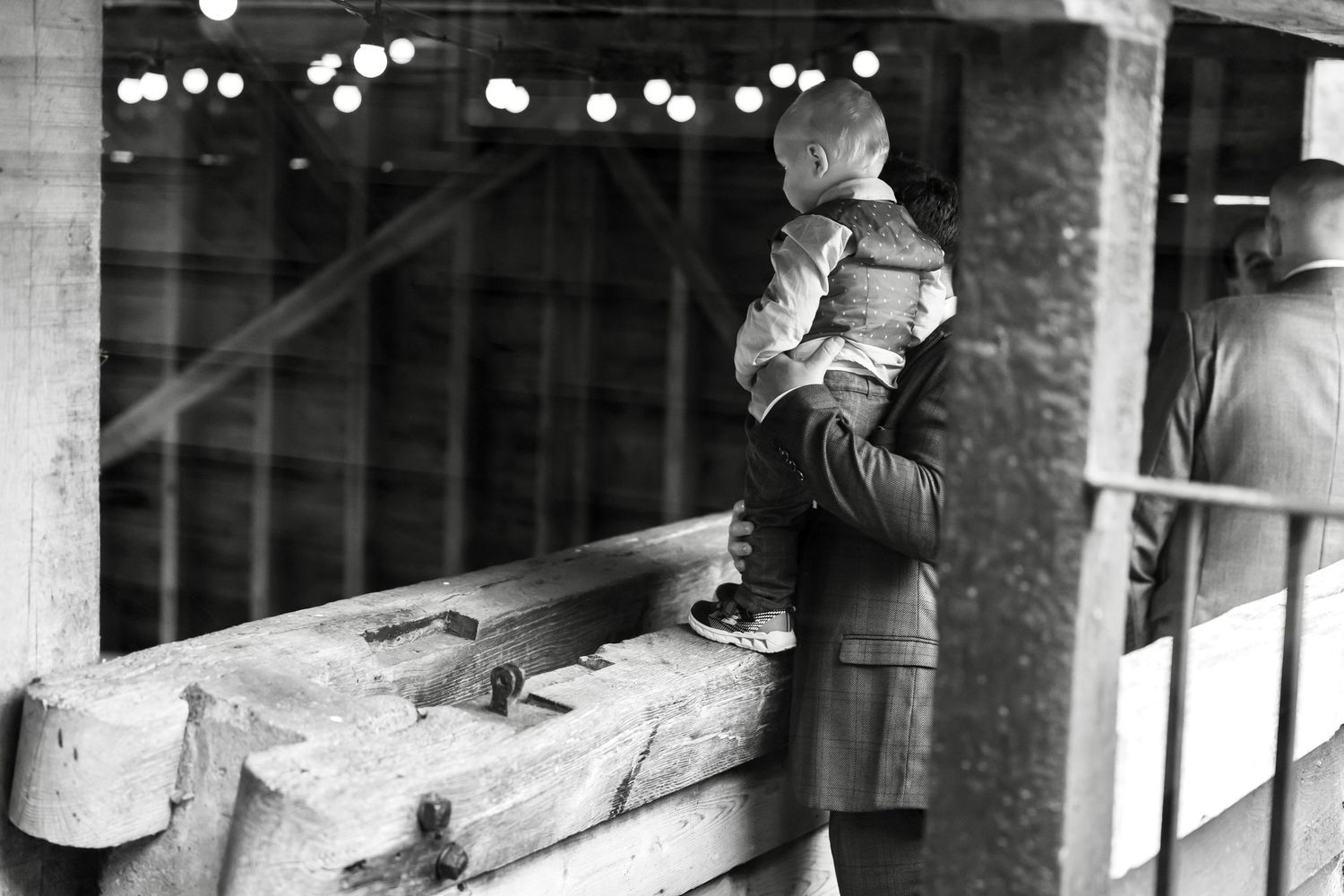 Black and white vintage architectural detail with string lights creating bokeh effect.