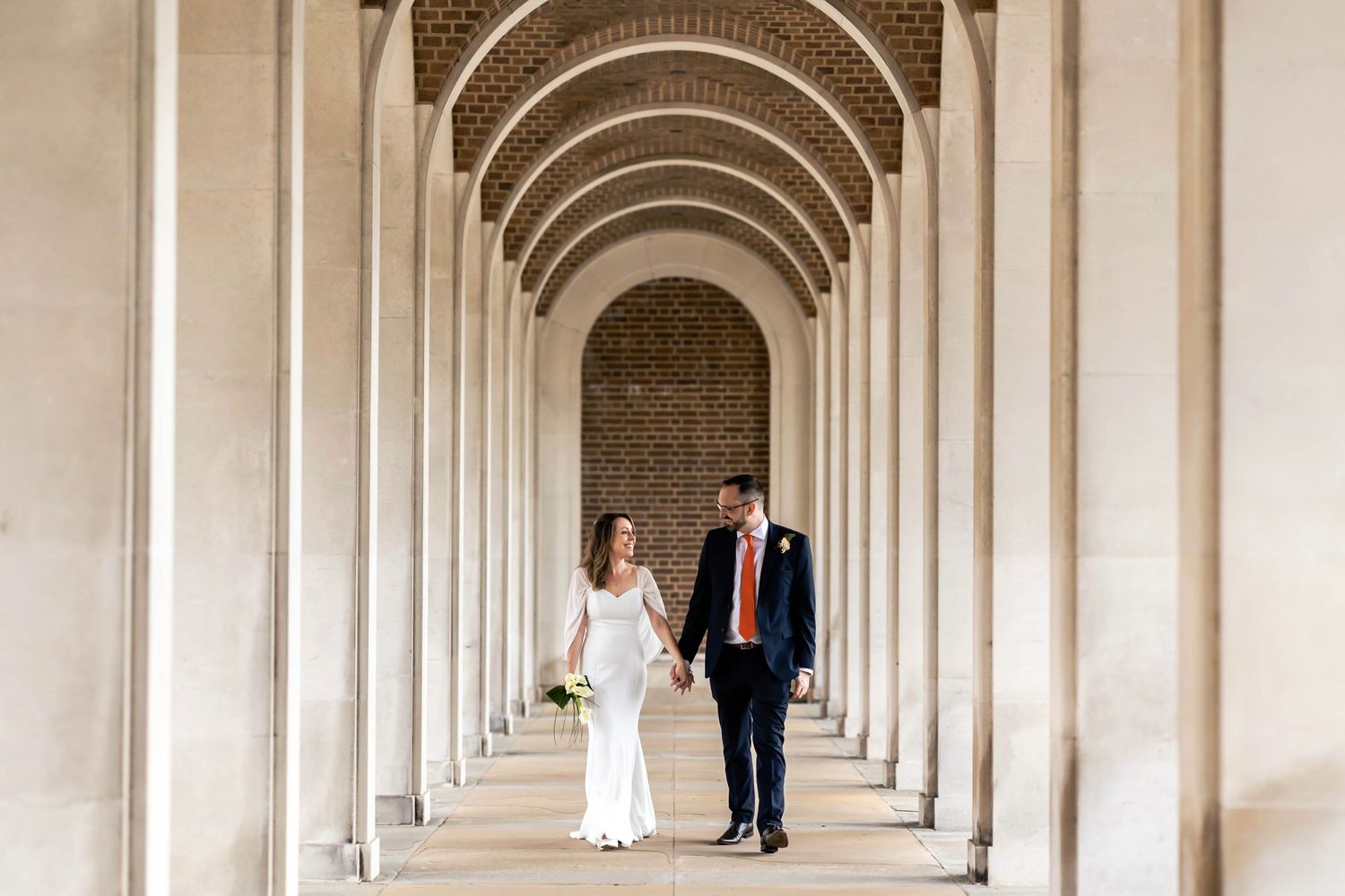 Elegant white archways create a dramatic colonnade perspective in the architectural setting at Hertford Registry Office, Hertfordshire.