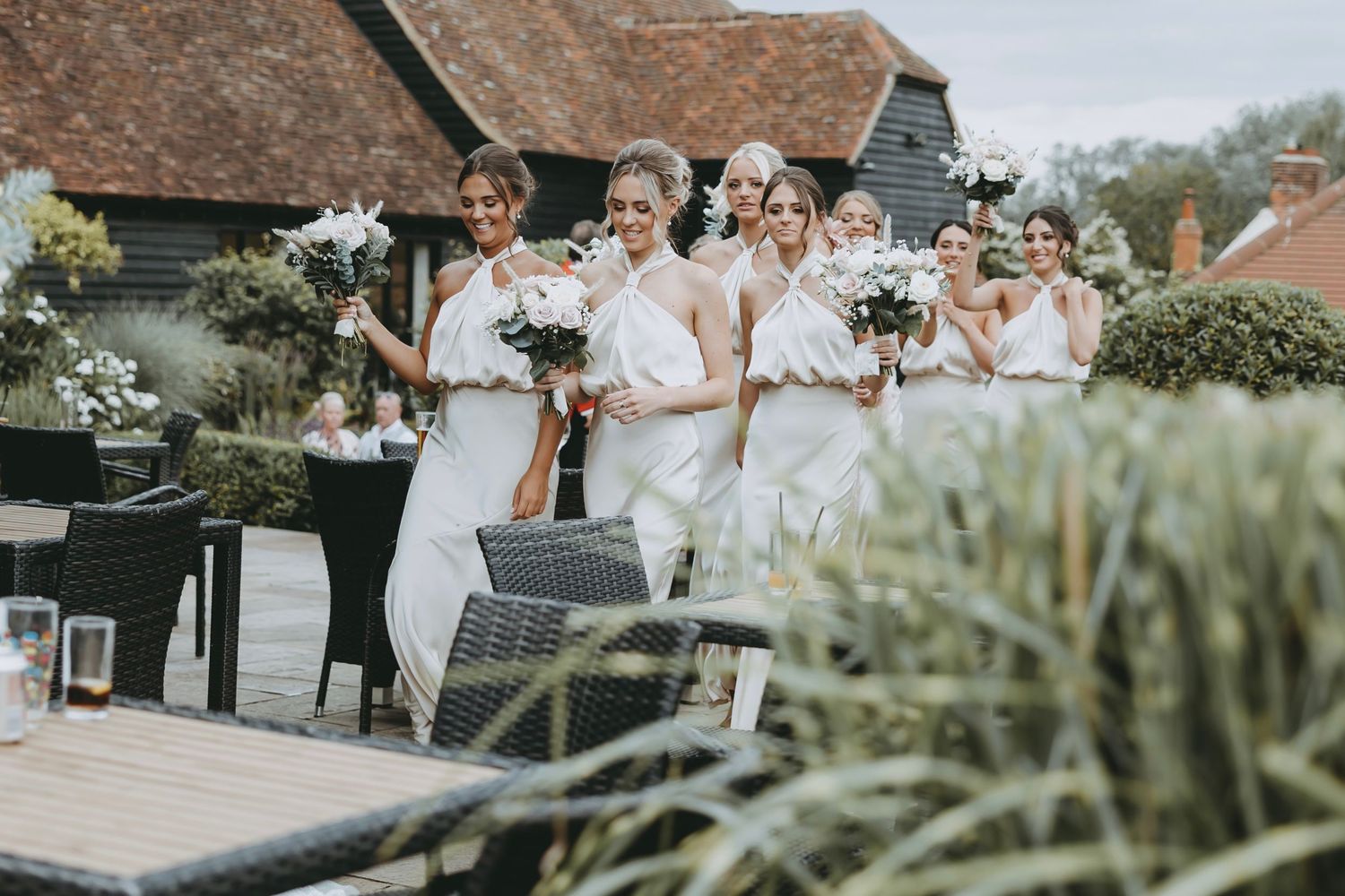 Scenic view of rustic wedding venue with brick buildings and landscaping.
