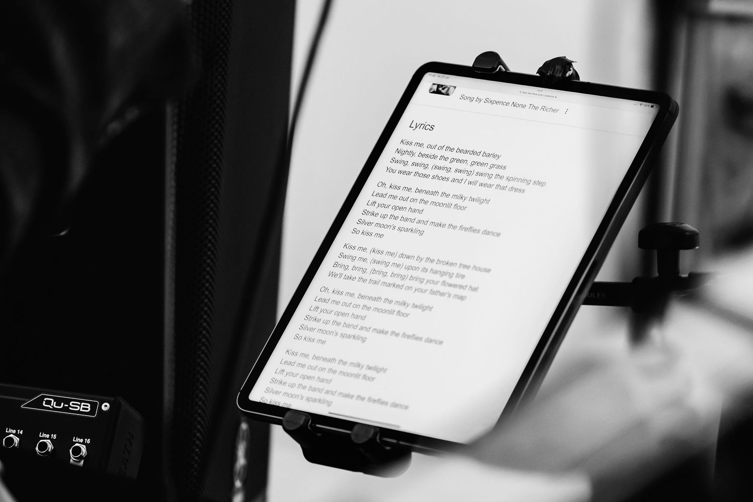 Digital tablets displaying wedding ceremony text in a dark setting.
