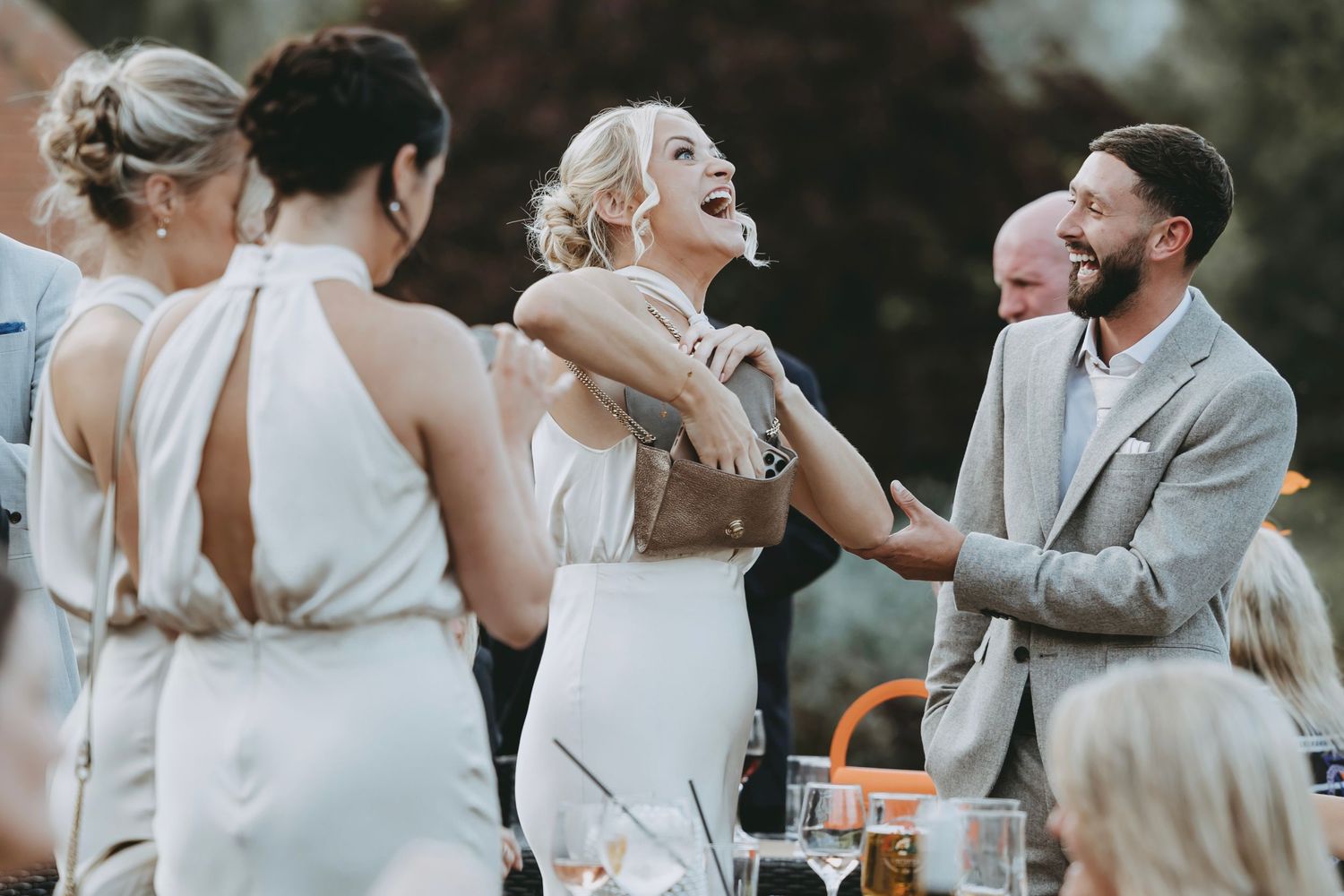 Guests enjoying a lively celebration at an outdoor wedding reception.