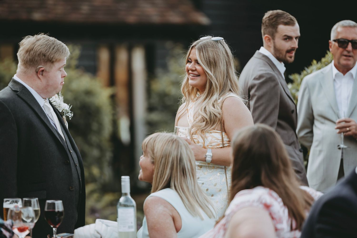 Wedding guests mingling and chatting during outdoor cocktail hour.