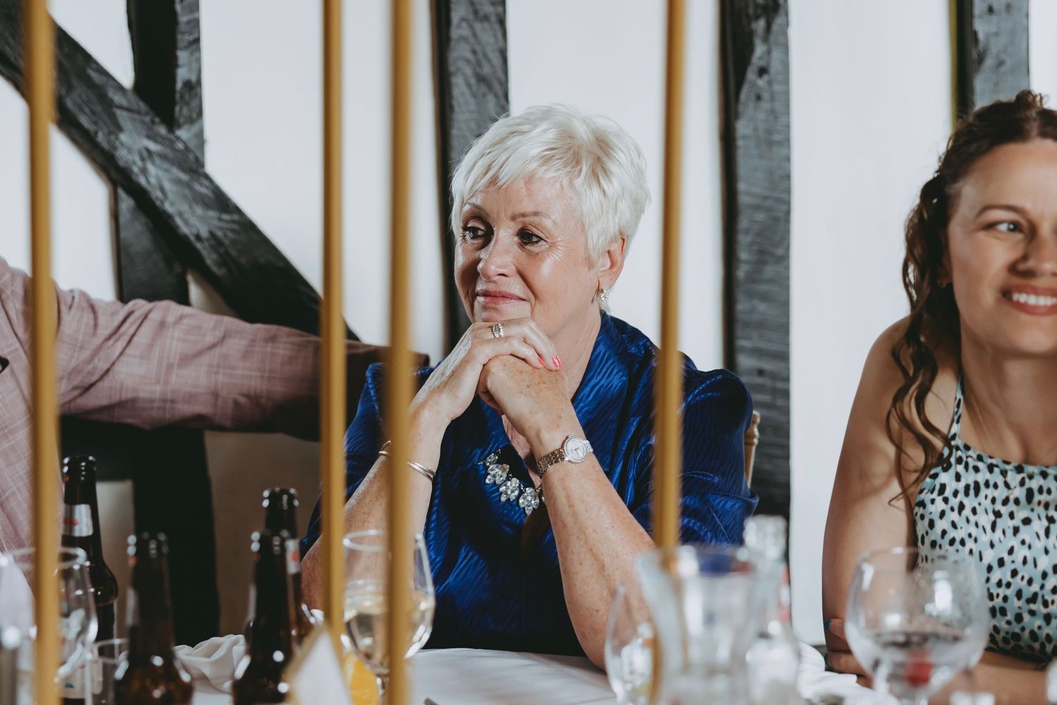 Candid moments of wedding guests dining and socializing at an elegant reception.