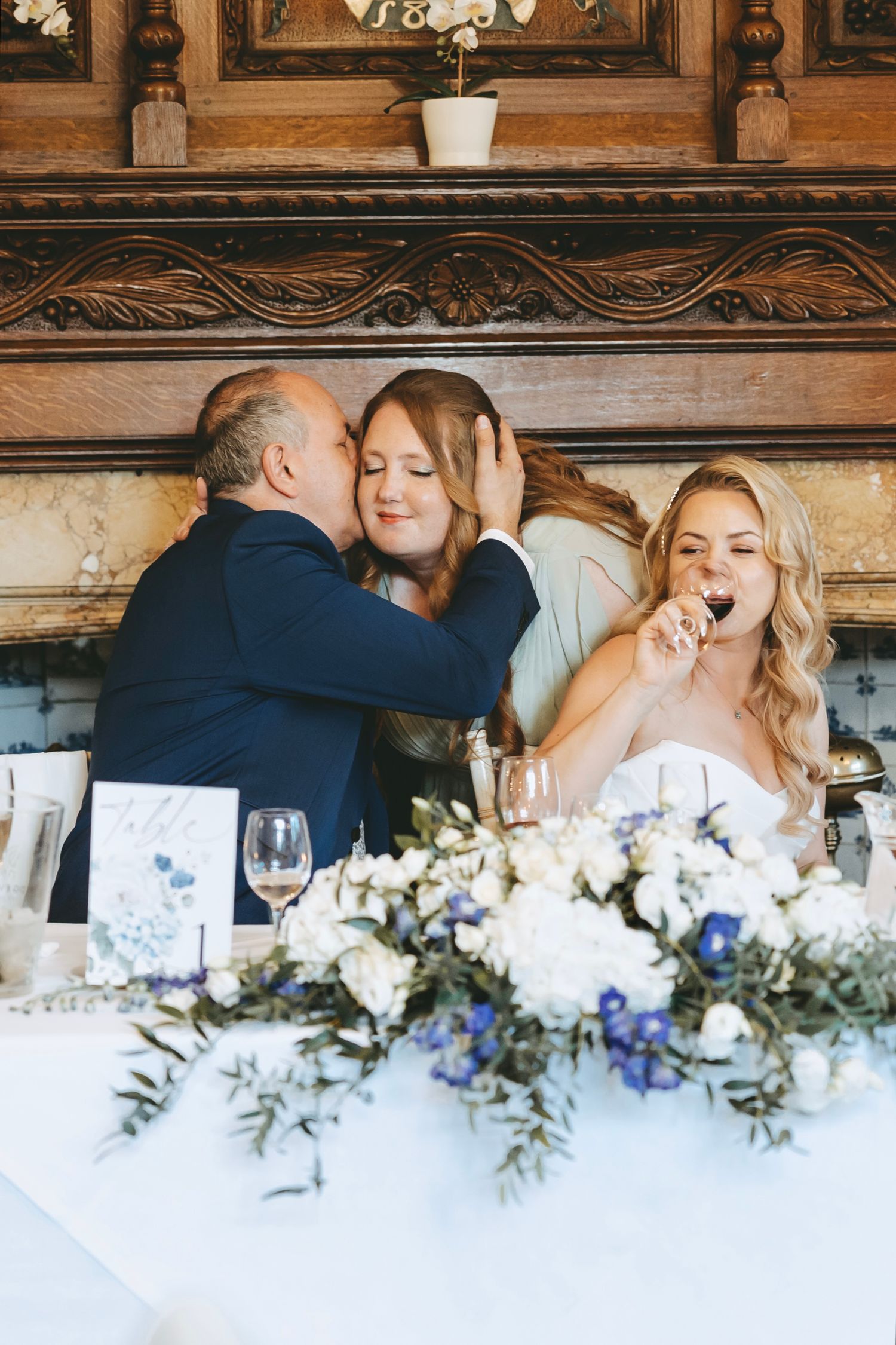 Wedding reception table with elegant white floral centerpieces and emotional moments.