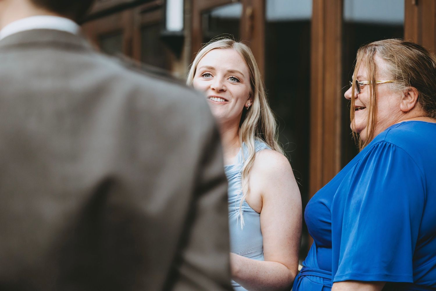 Guests engaged in conversation at an outdoor wedding celebration.