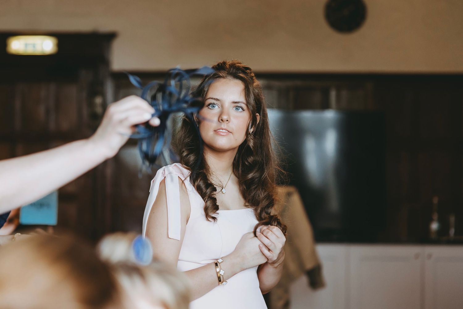 Wedding party members share candid moments during preparation time.