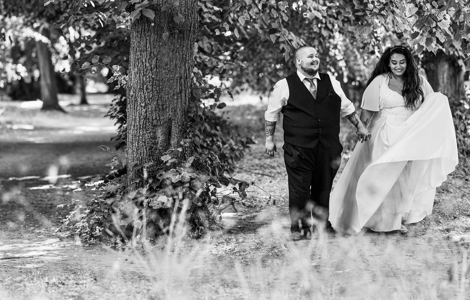 A romantic outdoor wedding photo session showing tender moments between a couple in a natural garden setting.