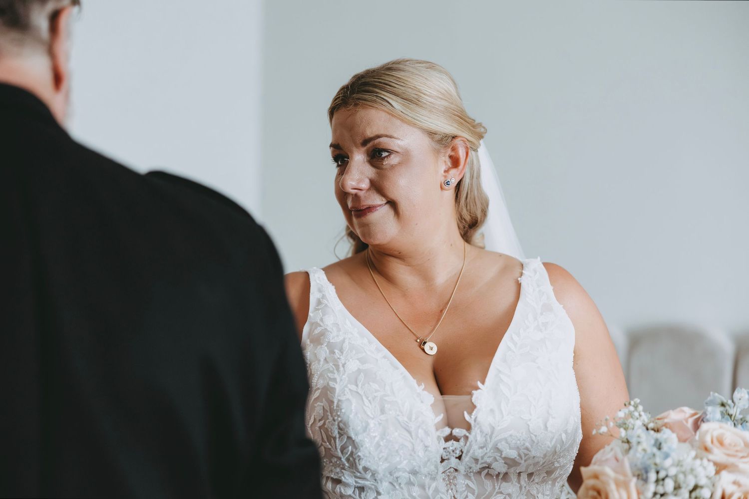Intimate wedding preparation scene with soft natural lighting.