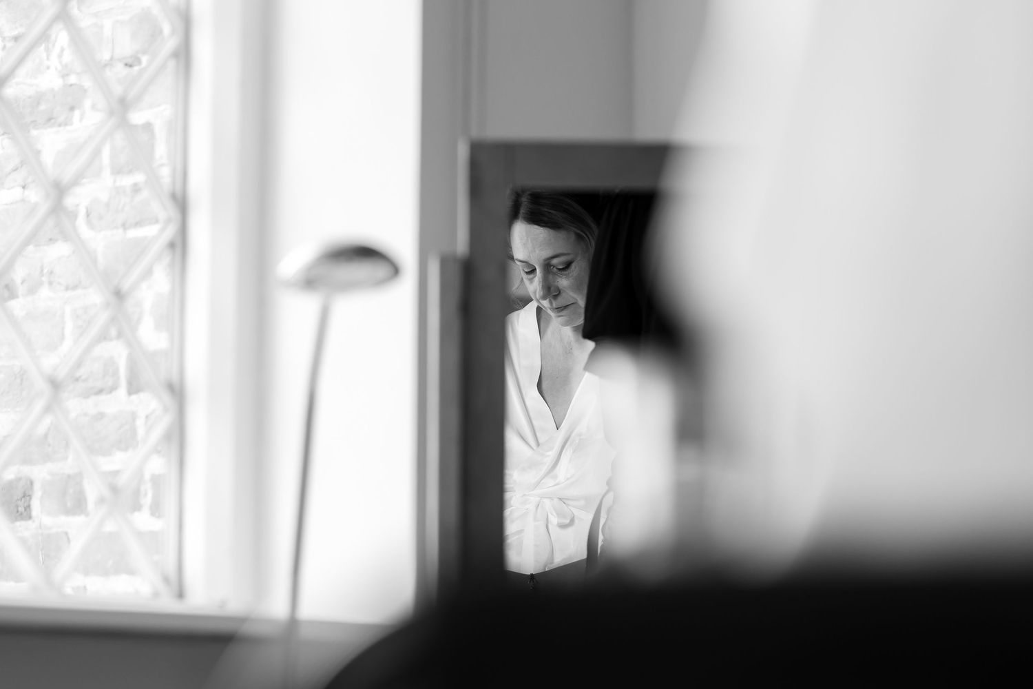 Artistic black and white photo through window with soft natural lighting.